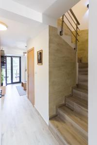 a staircase in a house with wooden floors at Apartman Maslacak in Divčibare