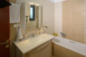 a bathroom with a sink and a bath tub at Luxury Dafnis House in Veria