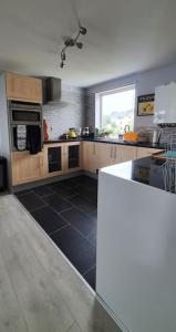 a large kitchen with a black tile floor at 'Ar Y Tonnau' Y Felinheli Waterside Apartment in Y Felinheli