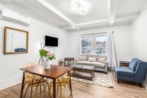 a living room with a table and a couch at North End Treasure, beautiful 2 bedroom apartment in Detroit