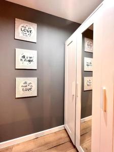 a hallway with a door to a room with words on the wall at GOOD PLACE 4U Apartament na Jurze in Zawiercie