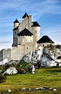 a large castle sitting on top of a mountain at GOOD PLACE 4U Apartament na Jurze in Zawiercie