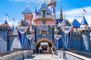 a disney castle with people walking in front of it at Lovely 2BR/2BA!5MIN to Disney! Angelstadium! HondaCenter. in Anaheim
