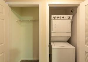 a white washer and dryer in a small closet at Lovely 2BR/2BA!5MIN to Disney! Angelstadium! HondaCenter. in Anaheim