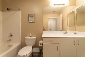 a bathroom with a toilet and a sink and a mirror at Lovely 2BR/2BA!5MIN to Disney! Angelstadium! HondaCenter. in Anaheim +17 photos