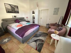 a bedroom with a bed and a living room at Simply Good Appartment in Borna