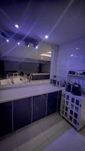 a kitchen with a white counter top in a room at درة العروس فيلا البيلسان الشاطي الازرق in Durat Alarous