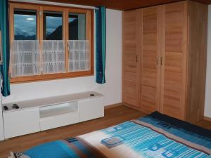 1 dormitorio con cama y ventana en Energy Lodge, en Kandersteg