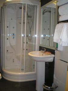 a bathroom with a shower and a sink at Apartamentos Plaza España Deluxe in Zaragoza