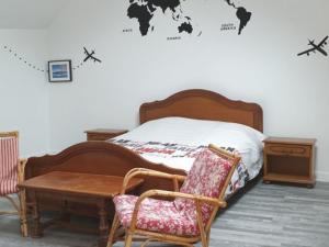 a bedroom with a bed with a table and chairs at La Picardière in Perdreauville +34 photos