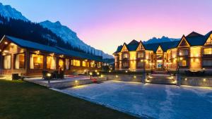 a luxurious house with a swimming pool at night at Hotel Village Walk in Sonāmarg
