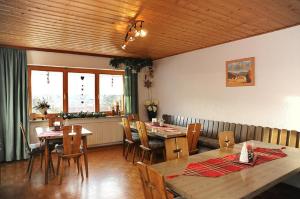 a dining room with wooden tables and chairs at Pension Waldeck in Langdorf im Landkreis Regen