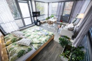 a bedroom with a bed in a room with windows at Atelier Lanna in České Budějovice