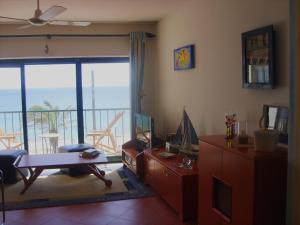 a living room with a view of the ocean at Sesimbra4you in Sesimbra