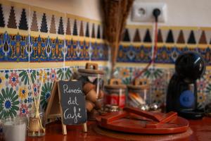 a kitchen counter with a chalkboard sign on a table at Casa Frasquita in Cehegín