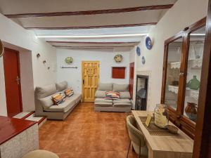 a living room with two couches and a table at Casa Frasquita in Cehegín