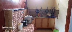 a small kitchen with a sink and a counter at Chez Mimi in Mahébourg