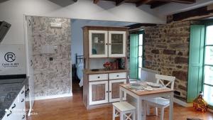 a kitchen with a table and a cabinet in a room at Casa el rey 12 - Apartamentos Buenos Aires y Figueras 