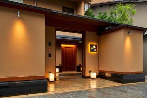 a hallway of a building with a red door at Sora Niwa Terrace Kyoto Bettei in Kyoto