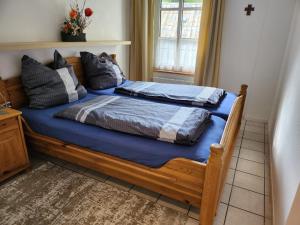 a bedroom with two beds with blue sheets at Gästehaus Beurener Mühle in Bad Bertrich