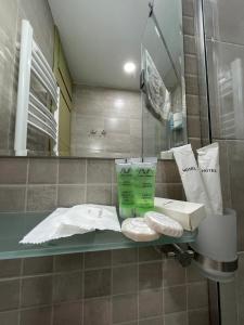 a bathroom with a counter with towels and a mirror at LT-Home in Tbilisi City