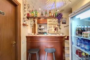 a bar in a restaurant with two stools at Hotel Artorius in Rome