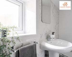 a white bathroom with a sink and a mirror at Stylish Home 8 Guests - Liverpool - Free Wifi & Parking By Hinkley Homes Short Lets & Serviced Accommodation in Liverpool