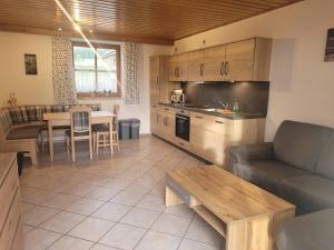 a kitchen and living room with a couch and a table at Bauernhof Nißl in Neunburg vorm Wald