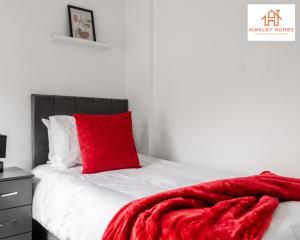 a red blanket laying on top of a bed at Stylish Home 8 Guests - Liverpool - Free Wifi & Parking By Hinkley Homes Short Lets & Serviced Accommodation in Liverpool