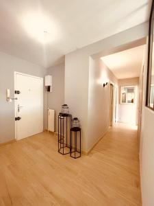 an empty room with a hallway with wood floors at La montagne ça vous gagne ! in Cluses