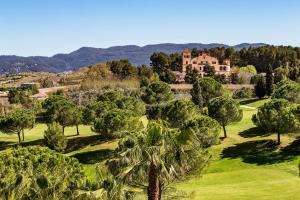 an aerial view of a mansion surrounded by trees at Hotel Barcelona Golf Resort 4 Sup in Martorell