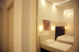 Postel nebo postele na pokoji v ubytování Hotel Fioralba