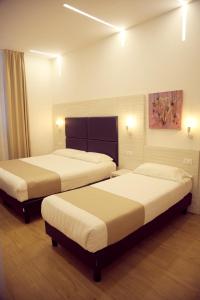 Postel nebo postele na pokoji v ubytování Hotel Fioralba
