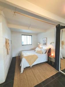 a bedroom with a bed and a window at Cute and Quirky Doves Nest Studio Walk to Werri Beach in Gerringong
