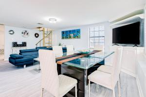 a dining room and living room with a glass table and chairs at Ocean Waves in Galveston