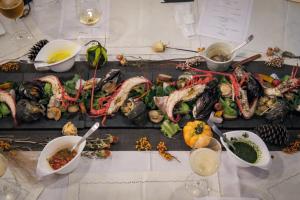 a table with many different types of food on it at HOSTEL OE in Yoshinogawa