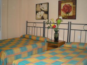 En eller flere senge i et værelse på Apartamentos Murallas