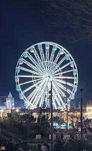 a large ferris wheel at a carnival at night at Entire spacious 4 bedroom apartment in Bournemouth in Bournemouth