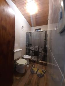 a bathroom with a toilet and a shower curtain at Casona Alma en Calma San Rafael in San Rafael