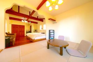 a bedroom with a bed and a table and chairs at 天からの贈り物 VillaMontpetre in Kirishima +42 photos