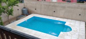 a blue swimming pool sitting on a patio at La casona in Merlo