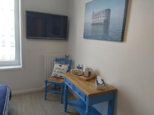 Habitación con mesa azul y 2 sillas en "chez Nat", en Chaillevette