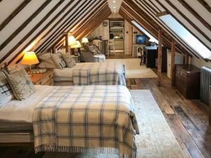 a bedroom with two beds in a attic at Old Rectory Loft in Fernhurst