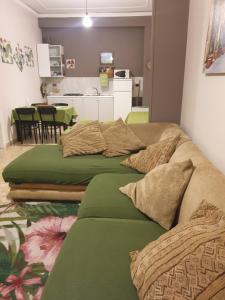 two green beds in a room with a kitchen at Dolce casa centro storico di Palermo new 2023 in Palermo