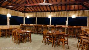 a dining room with wooden tables and chairs at Kelimutu Paradiso Resort in Kelimutu +20 photos