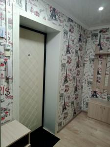 a room with a wall with hockey stickers on it at Квартиры in Shchūchīnsk