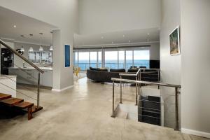 a living room with a view of the ocean at Bahari Villa in Simonʼs Town