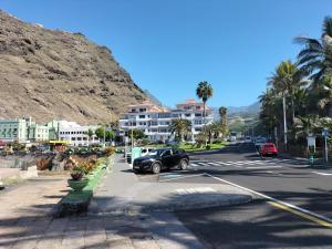 a car parked in a parking lot next to a mountain at Duplex ORION in Tazacorte