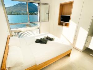 a bedroom with a bed and a large window at Chalet PAM - 1 line s'Albufera lake - near by beach in Alcudia
