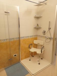 a shower with a chair in a bathroom at B&B Il Sentiero in San Sperate